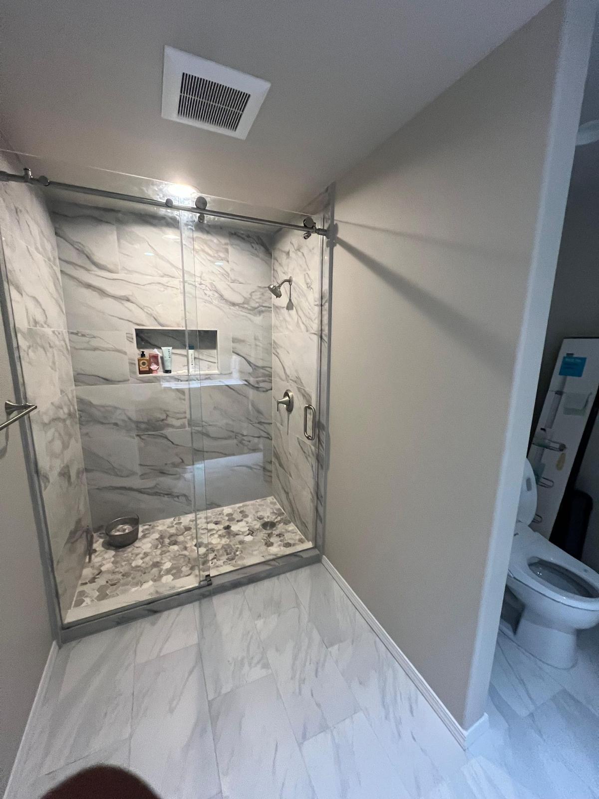 Bathroom vanity and lighting installation with modern fixtures in Seattle bathroom remodel